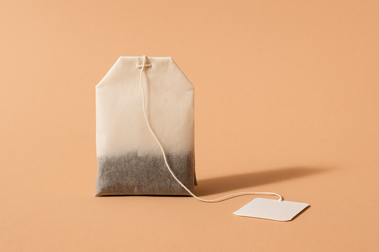 Simple tea bag on peach background